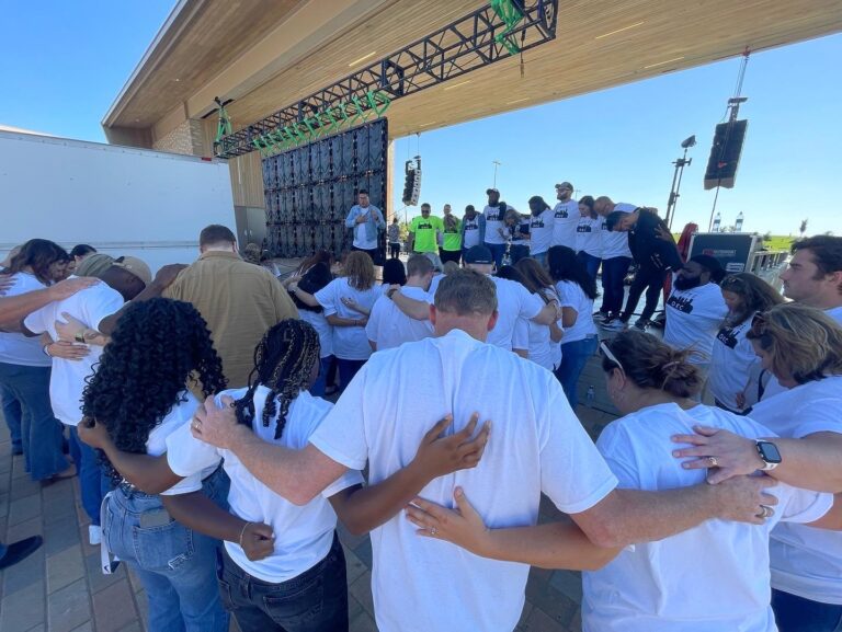 A group of people standing together holding hands